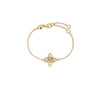 Yellow gold bracelet with mother of pearl and diamond flower charm on a white background