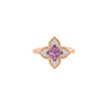 Gold ring featuring a four-pointed flower design with purple gemstone center and diamond pavé petals.