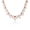 The TIARE' Diamond, Rubellite, and Mother of Pearl Collar Necklace by Roberto Coin showcases alternating mother of pearl petals and diamond-set leaves with rubellites at each flower's center, displayed on a white background.