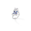 Side view of a white gold double floral bypass ring with diamonds and blue sapphires on a white background