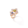 Side view of rose gold ring with mixed gemstones on a white background