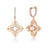 The VENETIAN PRINCESS PIROUETTE PAVE SMALL FLOWER DROP EARRINGS by Roberto Coin feature stylized 18K rose gold flowers with white enamel centers and pavé diamonds accenting both the petals and hoops.