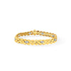 Gold bracelet with embedded stones on a white background