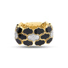 Front view of yellow gold and black enamel ring with white gold diamond accents on a white background