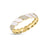Yellow gold and white enamel cuff bangle with diamond accents on a white background