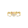 Front view of yellow gold and white enamel ring with diamond accent section on a white background
