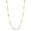 Yellow gold necklace with alternating bar and diamond bezel stations on a white background