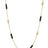 Yellow gold necklace with alternating black enamel bar and diamond bezel stations on a white background