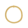 Yellow gold link bracelet with diamond accents on a white background