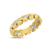 Side view of yellow gold ring with white gold and diamond accents on a white background