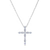 White gold cross necklace with emerald and round cut diamonds on a white background