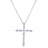 White gold cross necklace with emerald and round cut diamonds on a white background