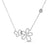 White gold open frame butterfly and flower necklace with pave diamond outline on a white background