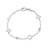 Yellow gold bracelet with open frame and diamond stations on a white background