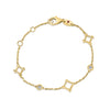 Yellow gold bracelet with open frame and diamond stations on a white background