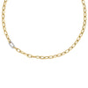 Yellow gold chain necklace with one white gold and diamond link on a white background