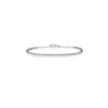 White gold diamond tennis bracelet with chain ends on a white background