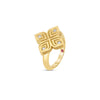 The ARABESQUE LARGE DIAMOND FLOWER RING by Roberto Coin showcases a geometric floral design in 18K yellow gold, with diamonds at each petal’s center and a small pink gemstone on the band, set against a plain white background.