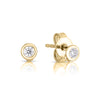 The CLASSIC DIAMOND STUD EARRINGS by Roberto Coin are 18K gold studs with round, bezel-set diamonds. Shown on a white background, one earring lies flat while the other stands upright.