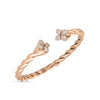 The LOVE IN VERONA DIAMOND TWIST BANGLE by Roberto Coin is an 18K gold bangle with a twisted design, diamond-studded floral motifs on each end, and a pink gemstone accent on the band.