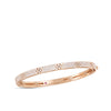 Rose gold bangle bracelet with diamonds on a white background