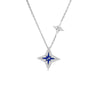 The Roberto Coin STARDUST SMALL PAVE DIAMOND AND BLUE CERAMIC STAR NECKLACE features a pavé diamond star with a blue ceramic center and a smaller silver star charm on an elegant 18K white gold chain.