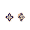 The VENETIAN PRINCESS DIAMOND AND LAPIS FLOWER STUD EARRINGS by Roberto Coin feature 18K gold four-petal flowers with gold outlines, navy blue lapis borders, and sparkling diamond centers, shown from the front and at an angle.