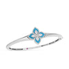The VENETIAN PRINCESS DIAMOND AND TURQUOISE KNIFE EDGE BANGLE by Roberto Coin features a flower centerpiece with turquoise petals outlined and accented by sparkling diamonds.