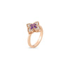 The Roberto Coin Venetian Princess Carnival Pave Diamond and Amethyst Small Flower Ring, crafted in 18K rose gold with a flower-shaped design featuring an amethyst center and pave diamonds, is displayed on a white background.