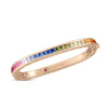 The PRINCESS MULTI SAPPHIRE SQUARE BANGLE by Roberto Coin is a gold bracelet with square-cut, rainbow-gradient sapphires. The inside is engraved with "ROBERTO COIN" and features a signature small red gemstone.